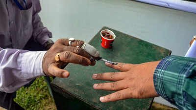 dibrugarh an election official marks the finger of a polling official with inde