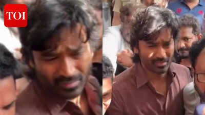dhanush looks visibly shaken and consoles close friend shanthanu bhagyaraj while paying last respects to director k watch